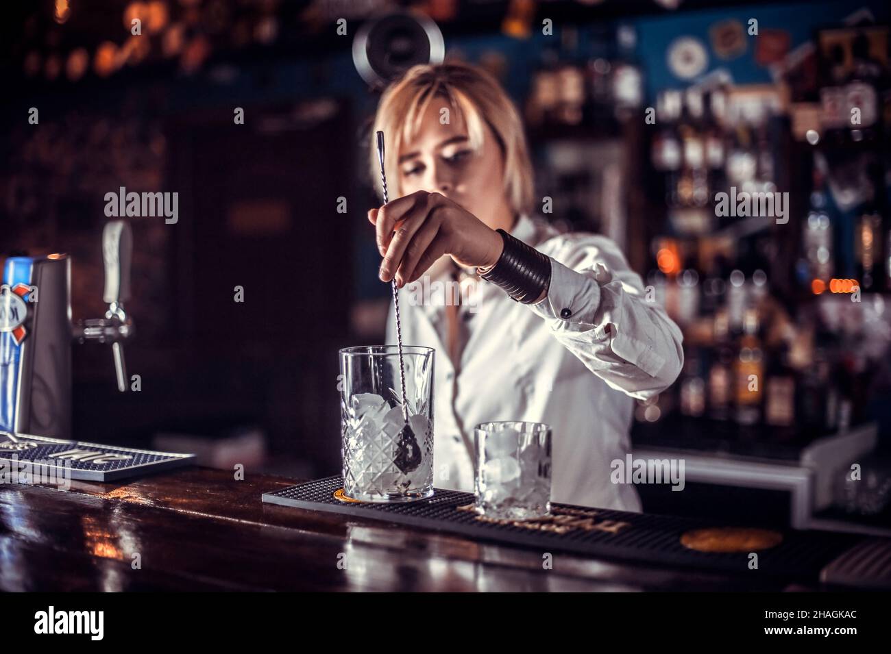 Girl barman formulates a cocktail on the beerhouse Stock Photo