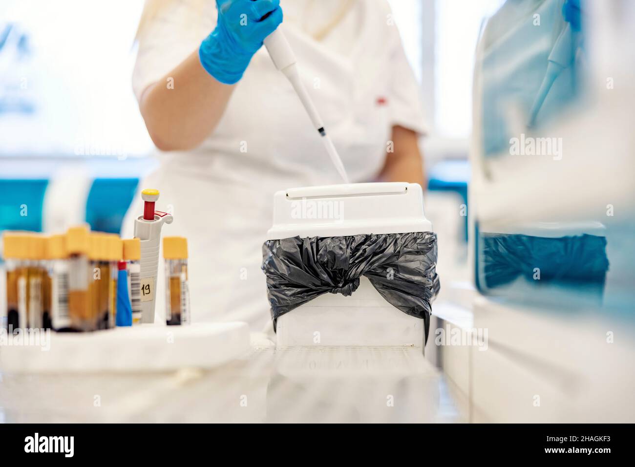 Medical waste in lab. A nurse taking care of medical waste after blood