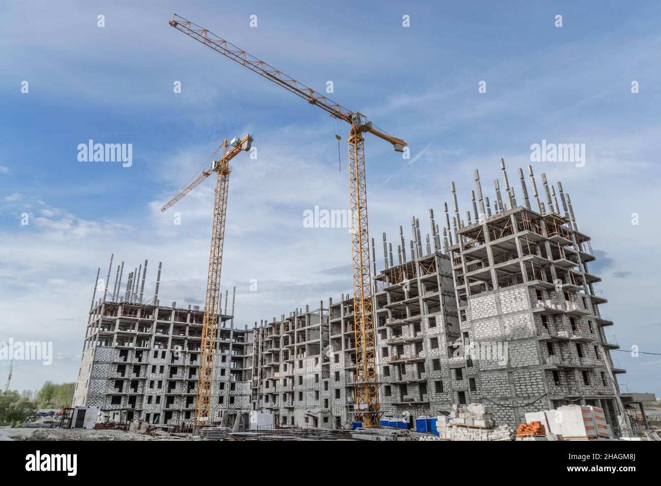 Building crane and building under construction against blue sky Stock Photo