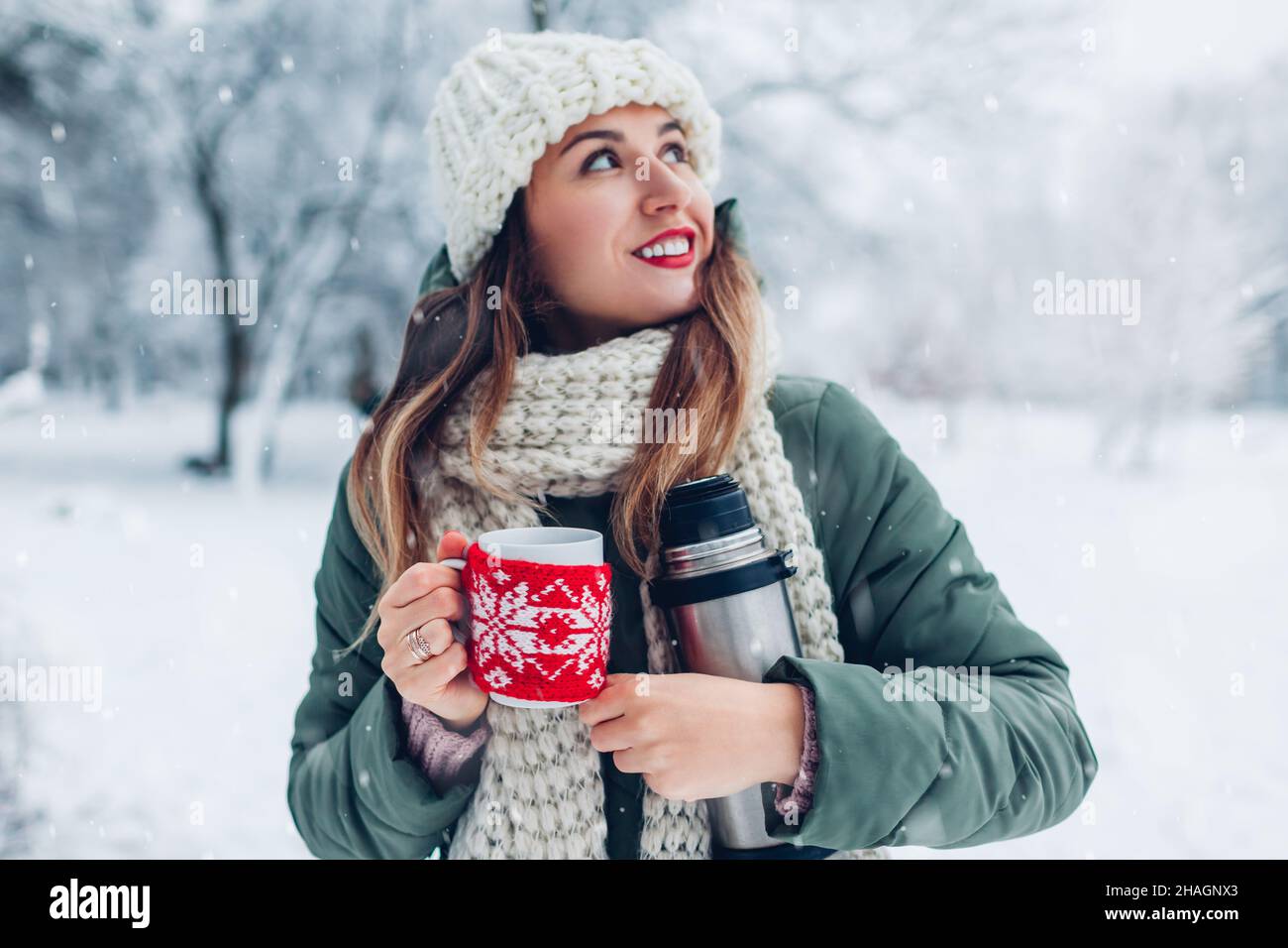 Thermos With A Steaming Mug Of Hot Drink Stands In The Snow Winter