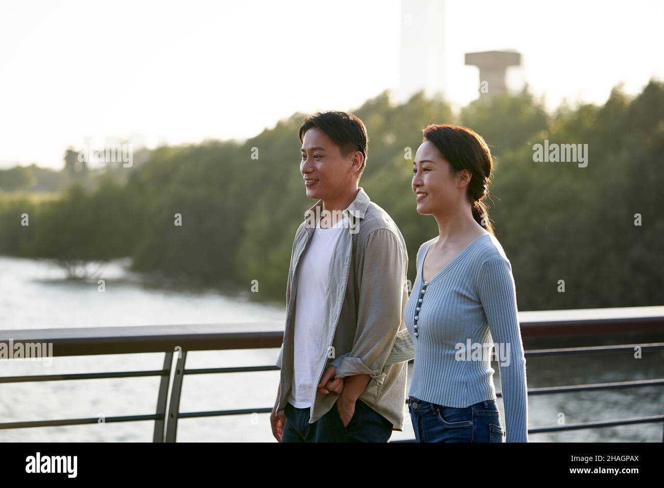 young asian couple taking a walk in city park Stock Photo