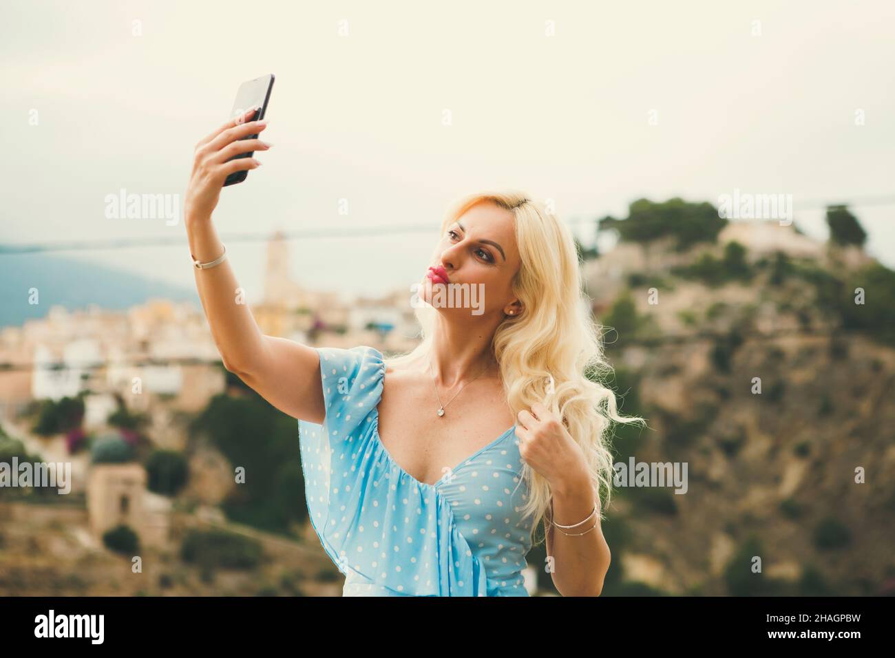 pretty blonde woman in her 40s taking selfies Stock Photo