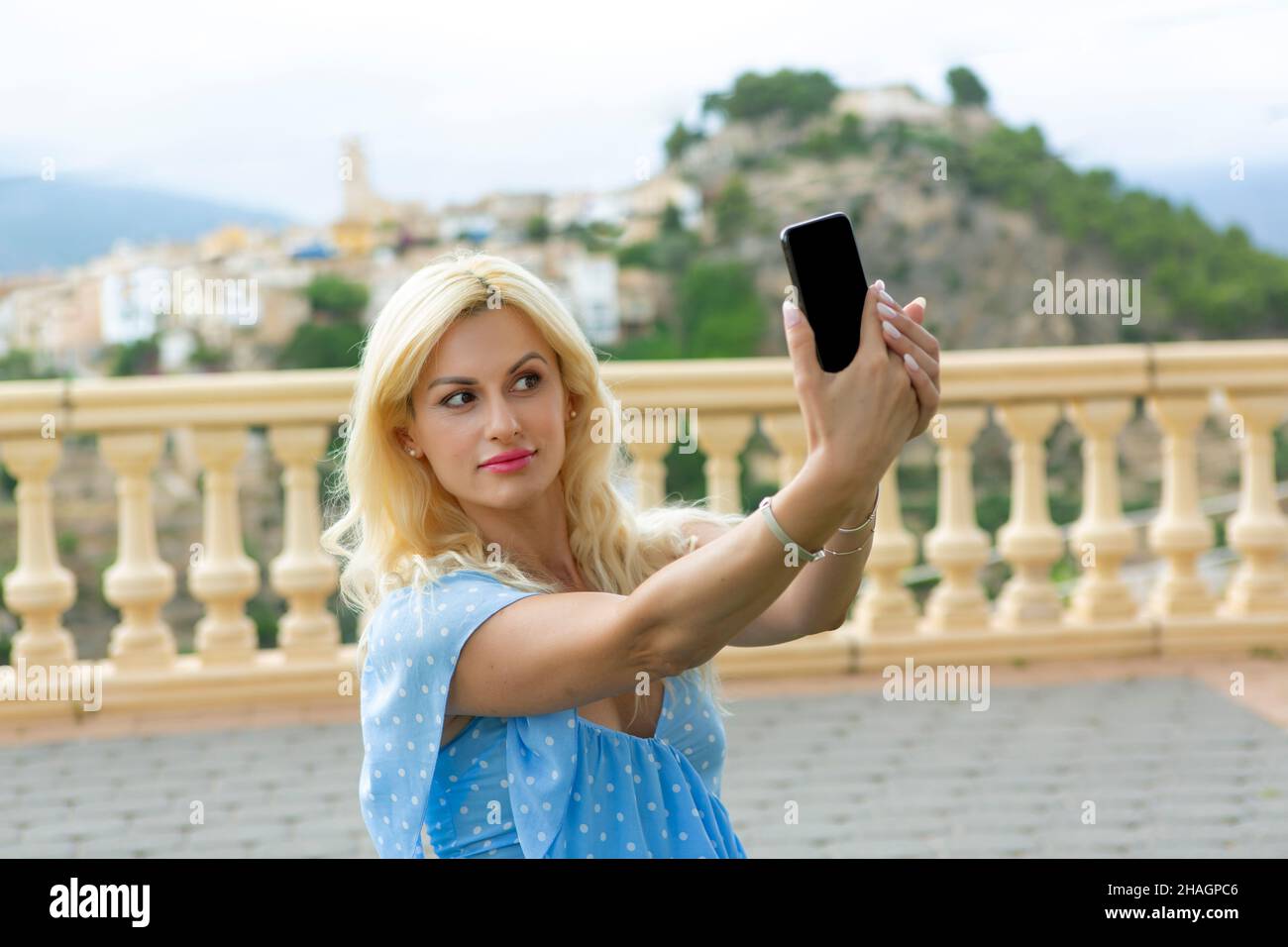 pretty blonde woman in her 40s taking selfies Stock Photo