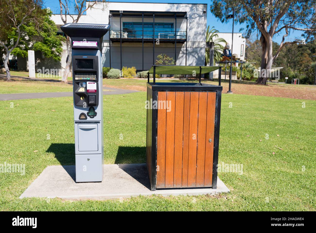 A solar powered parking meter and a public rubbish bin or trash can at