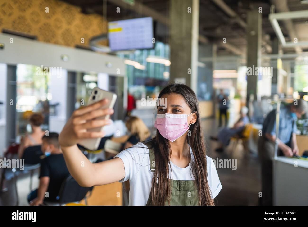 Young woman wearing mask uses hi-res stock photography and images - Alamy
