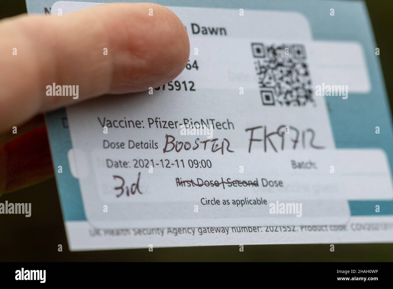 December 2021. A major effort is underway to get Covid booster jabs into arms as quickly as possible with the new Omicron variant of Covid-19 virus spreading rapidly in the United Kingdom population. Pictured is a Pfizer booster vaccination record card. Stock Photo