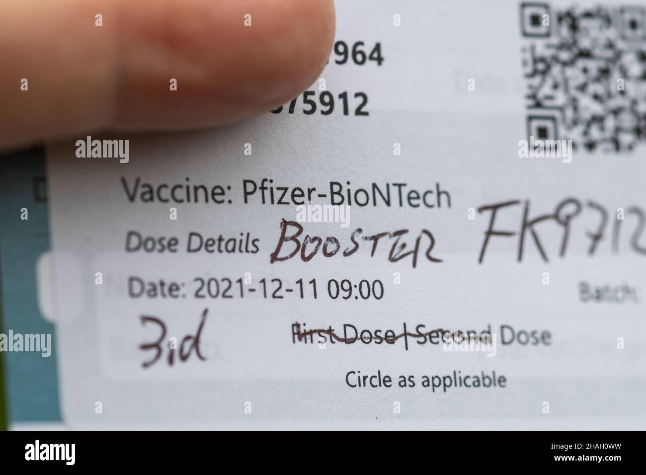 December 2021. A major effort is underway to get Covid booster jabs into arms as quickly as possible with the new Omicron variant of Covid-19 virus spreading rapidly in the United Kingdom population. Pictured is a Pfizer booster vaccination record card. Stock Photo