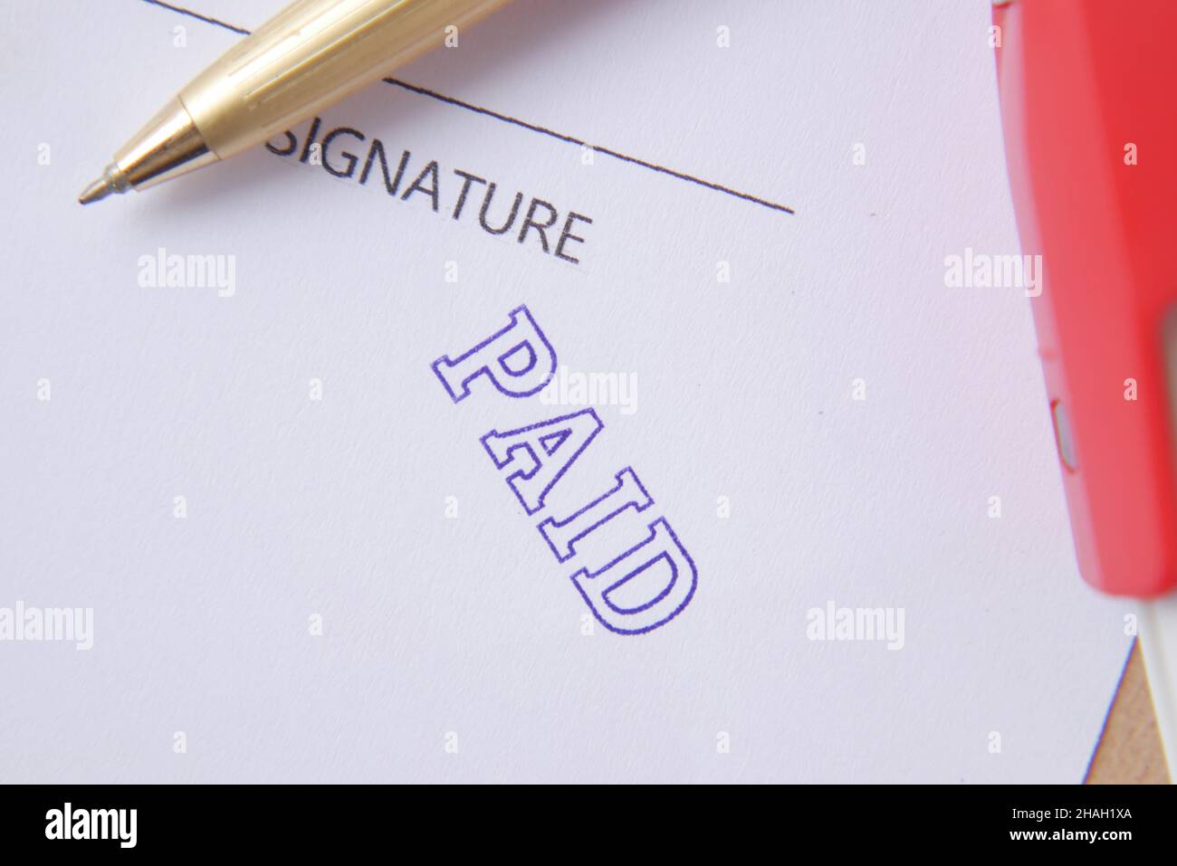 Paid invoice and Rubber Stamp on paper , Stock Photo