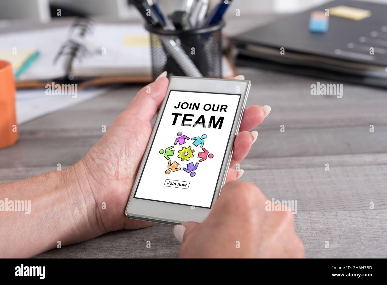 Female hand holding a smartphone with join our team concept Stock Photo ...