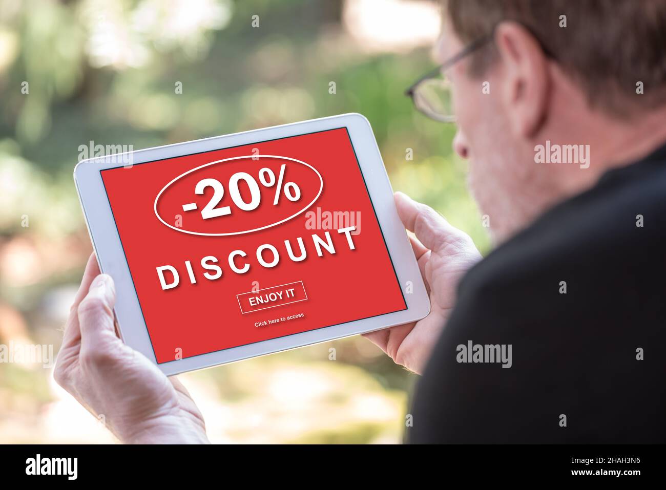 Tablet screen displaying a discount concept Stock Photo Alamy