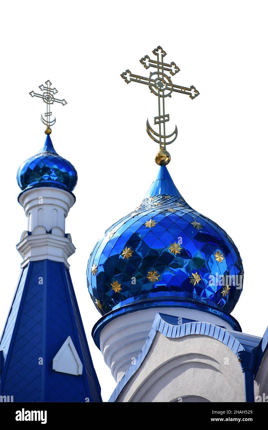 On a white background, under clipping, two domes of a Christian church in blue, of different sizes, with crosses at the top Stock Photo
