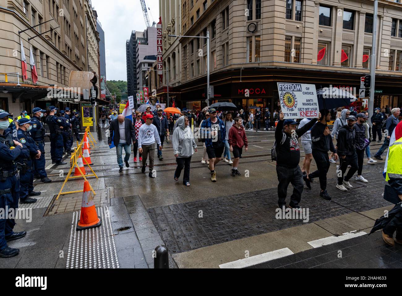 People on street marching in rally against government vaccine mandates. Activists demonstrating against vaccine passport in Australia Stock Photo