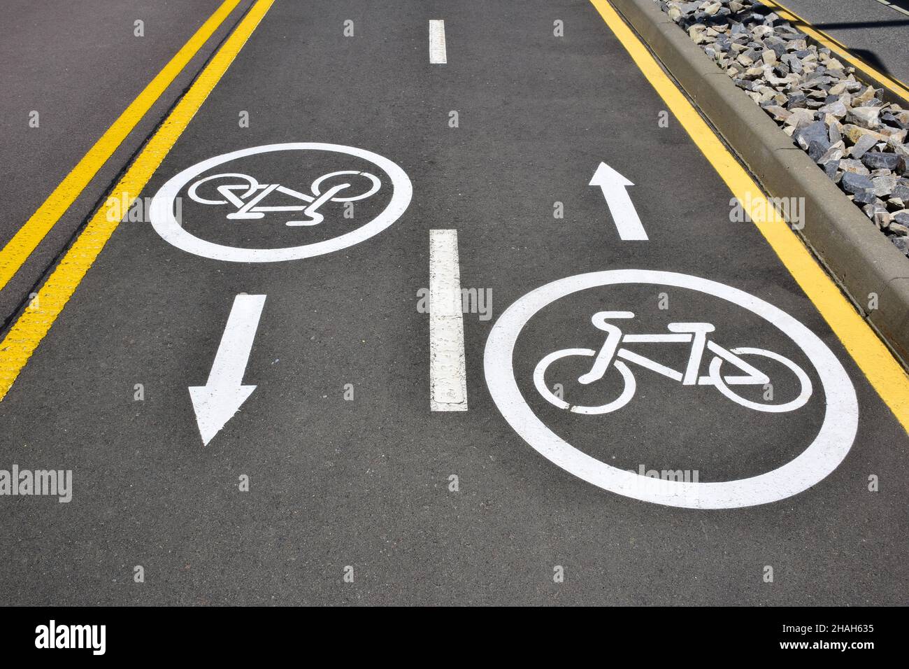 On the asphalt road signs for cyclists in both directions, allowing ...