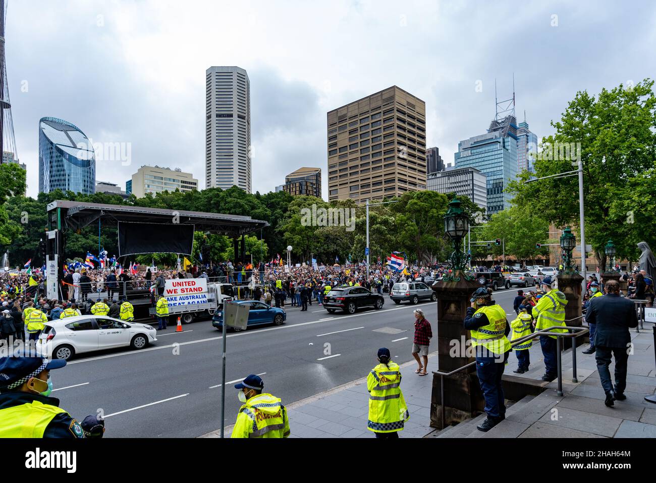 Large crowd of protesters against No Jab No Job policy of Australian government. In view are Sydney Eye Tower, buildings, road, cars and police force. Stock Photo