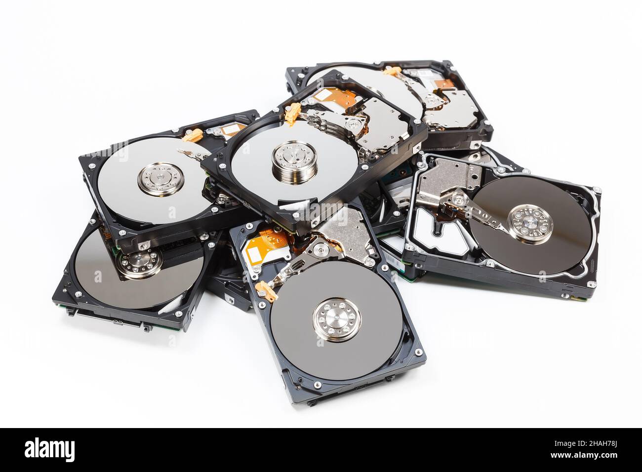 Pile of hard drives with open covers on white background Stock Photo