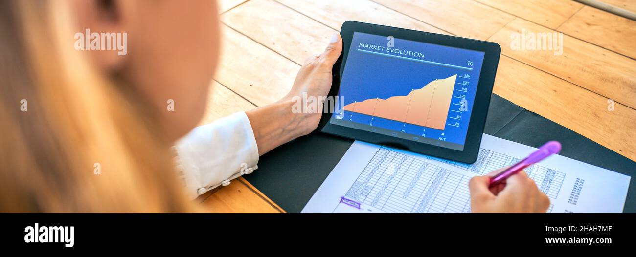 Businesswoman analyzing market evolution with tablet Stock Photo