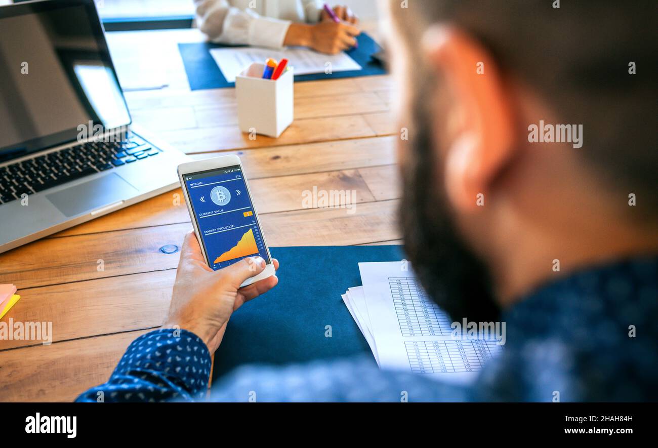 Businessman looking mobile with bitcoins information Stock Photo