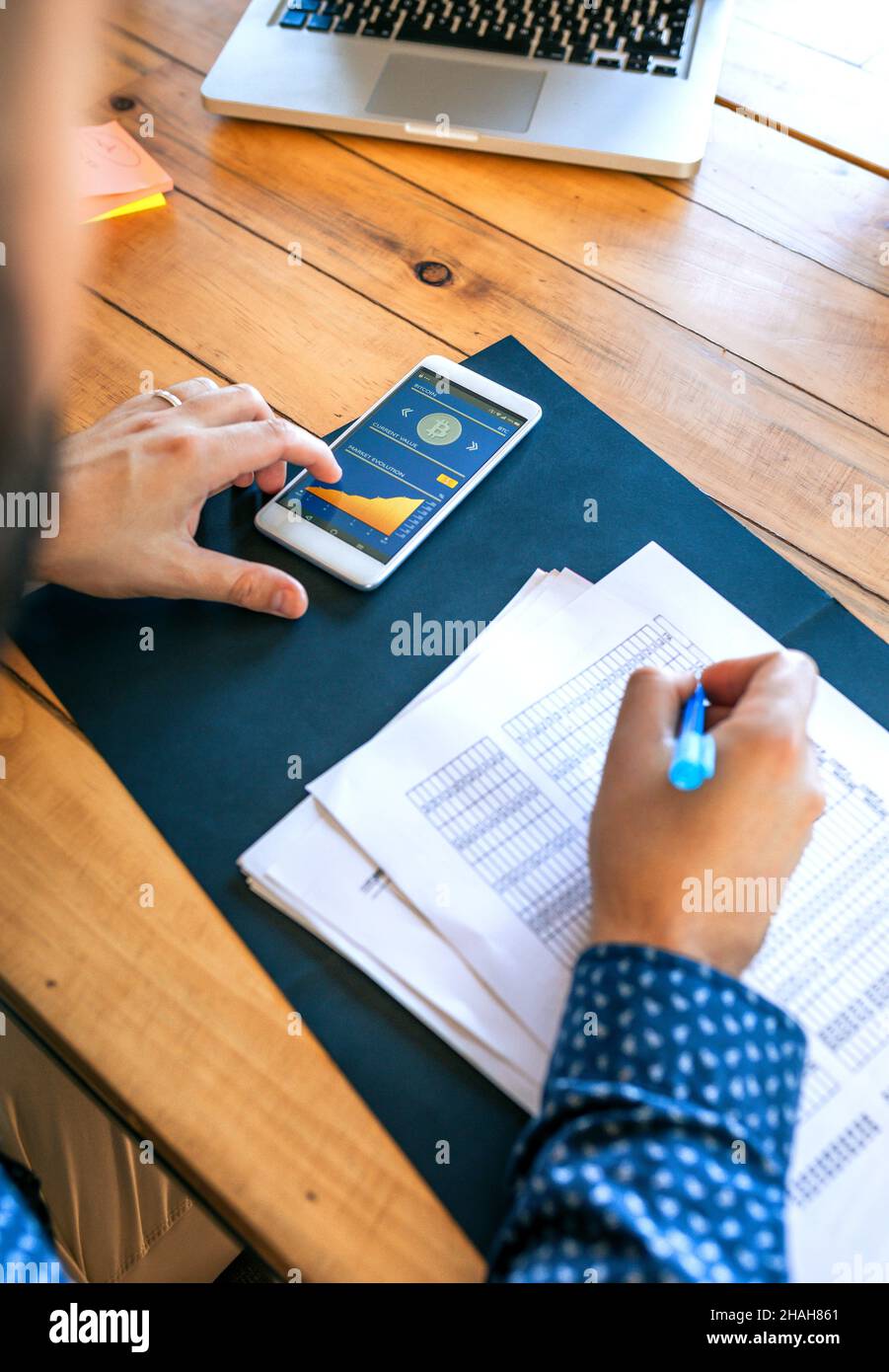 Unrecognizable businessman writing and touching mobile screen with bitcoins Stock Photo