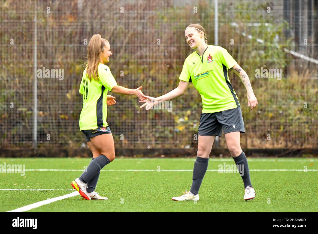 Neath, UK. 12th Dec, 2021. Chelsea Deacon of Briton Ferry Llansawel Ladies (left) is congratulated by team mate Mollie Jones after scoring her sides opening goal in the Genero Adran South match between Briton Ferry Llansawel Ladies and Merthyr Town Women at Neath Sports Centre in Neath, Wales, UK on 12, December 2021. Credit: Duncan Thomas/Majestic Media. Credit: Majestic Media Ltd/Alamy Live News Stock Photo