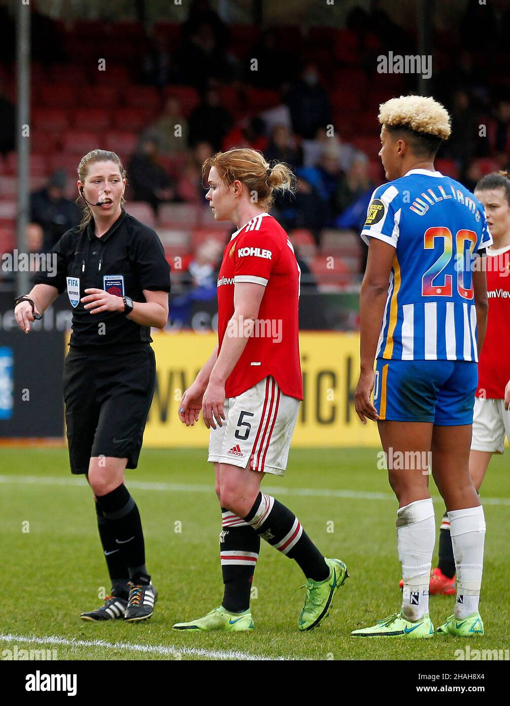 CRAWLEY, United Kingdom, DECEMBER 12: Referee, Abigail Byrne speaks to Aoife Mannion of Manchester United Women and Megan Connolly of Brighton & Hove Stock Photo