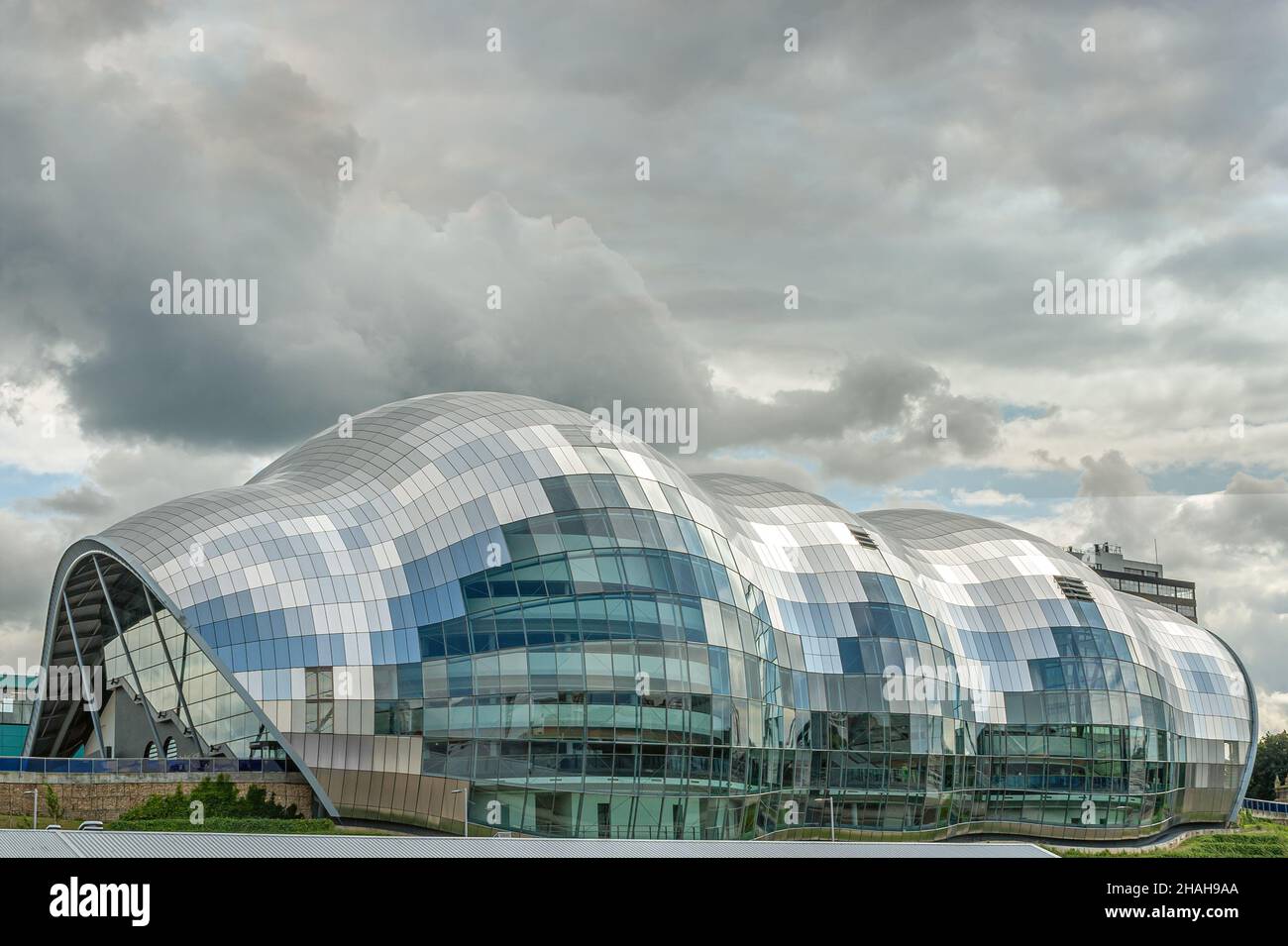 Dramatic clouds over the Sage Gateshead Concert Venue, North England, UK at dusk Stock Photo