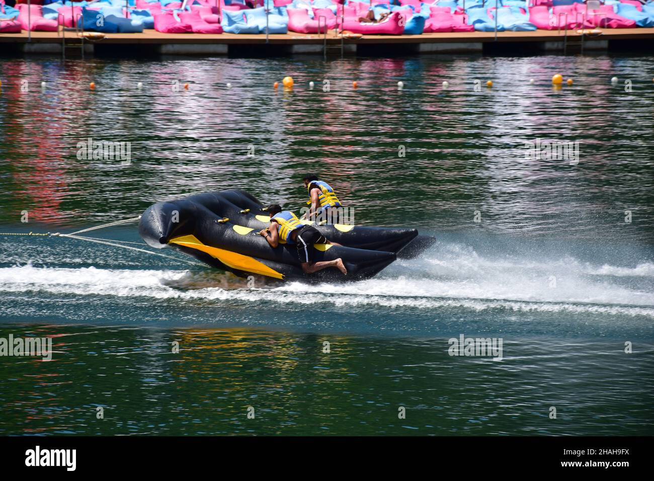 An inflatable sports raft with two men in life jackets quickly floats ...