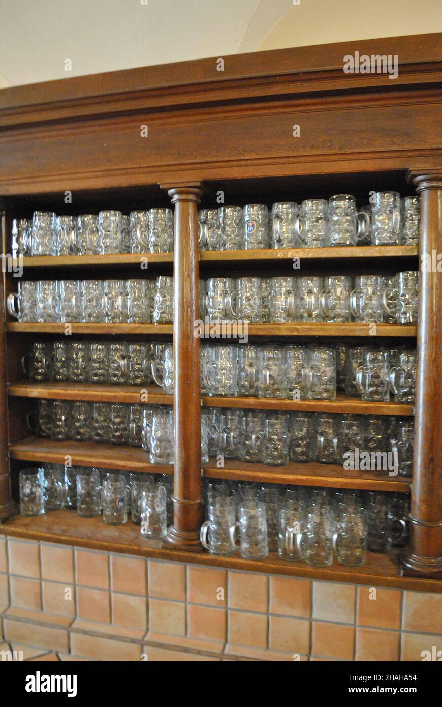 Large open decorative cabinet with wooden shelves for storing clean beer mugs stands in a brasserie Stock Photo