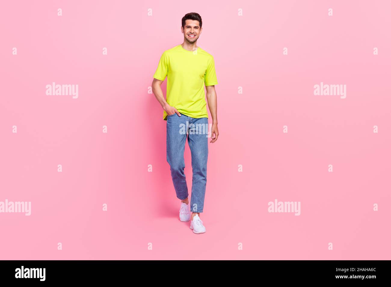 Full length body size photo man confident smiling in stylish outfit walking forward isolated pastel pink color background Stock Photo