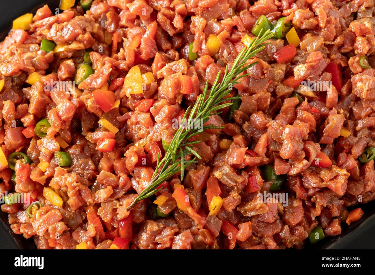 raw sauced diced meat on white wood background. Meat background. Meat