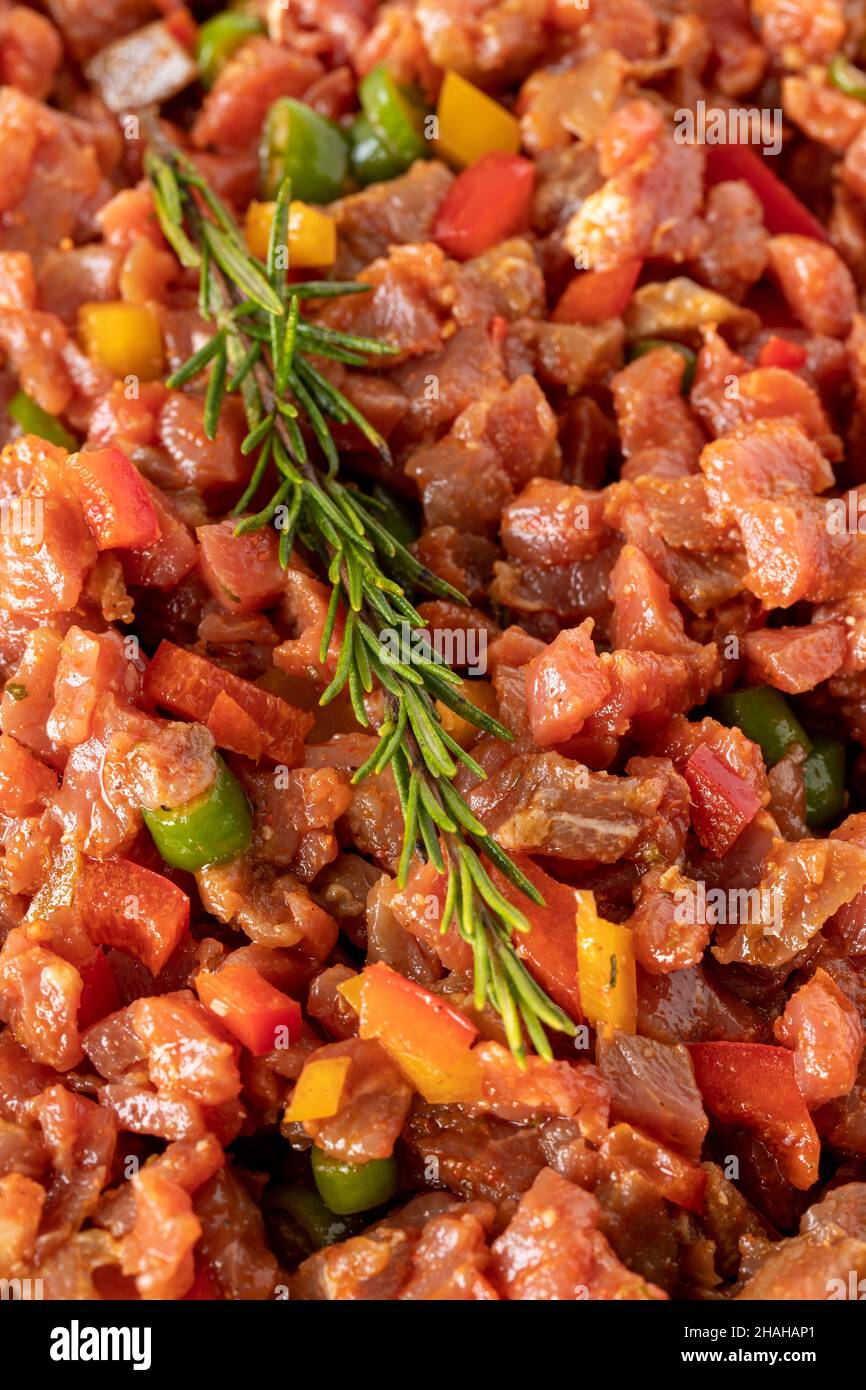 raw sauced diced meat on white wood background. Meat background. Meat
