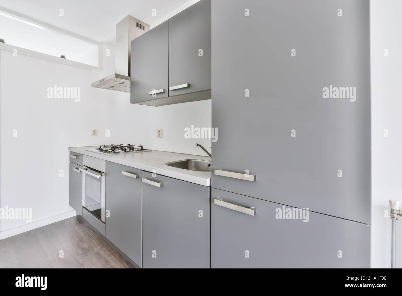 Elegant and cozy kitchen with gray kitchen unit Stock Photo - Alamy