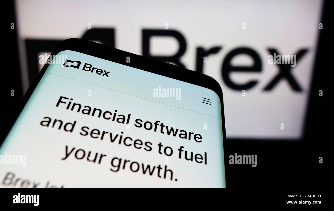 Mobile phone with website of US financial technology company Brex Inc. on screen in front of business logo. Focus on top-left of phone display. Stock Photo