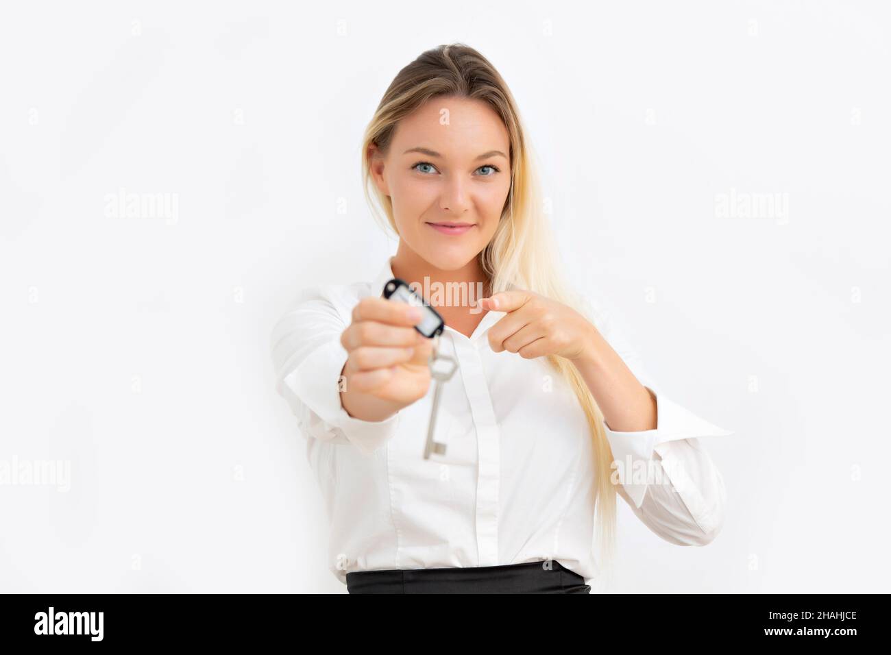 Young nordic blonde woman showing house keys Stock Photo
