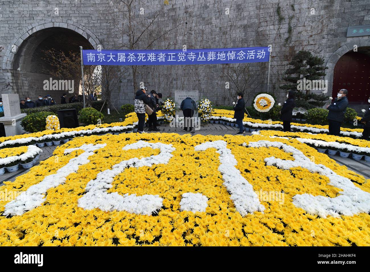 Nanjing, Dec. 13. 13th Dec, 1937. People take part in a memorial ceremony to mourn the victims of the Nanjing Massacre on the occasion of the eighth National Memorial Day in Nanjing, capital of east China's Jiangsu Province, Dec. 13, 2021. The Nanjing Massacre took place after the Japanese troops captured the city on Dec. 13, 1937. Over six weeks, they killed about 300,000 Chinese civilians and unarmed soldiers in one of the most barbaric episodes of World War II. Credit: Fang Dongxu/Xinhua/Alamy Live News Stock Photo