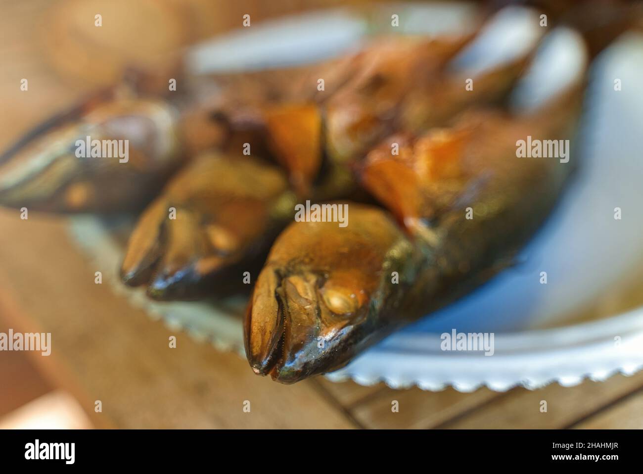 Fresh hot smoked mackerel on the table. Stock Photo