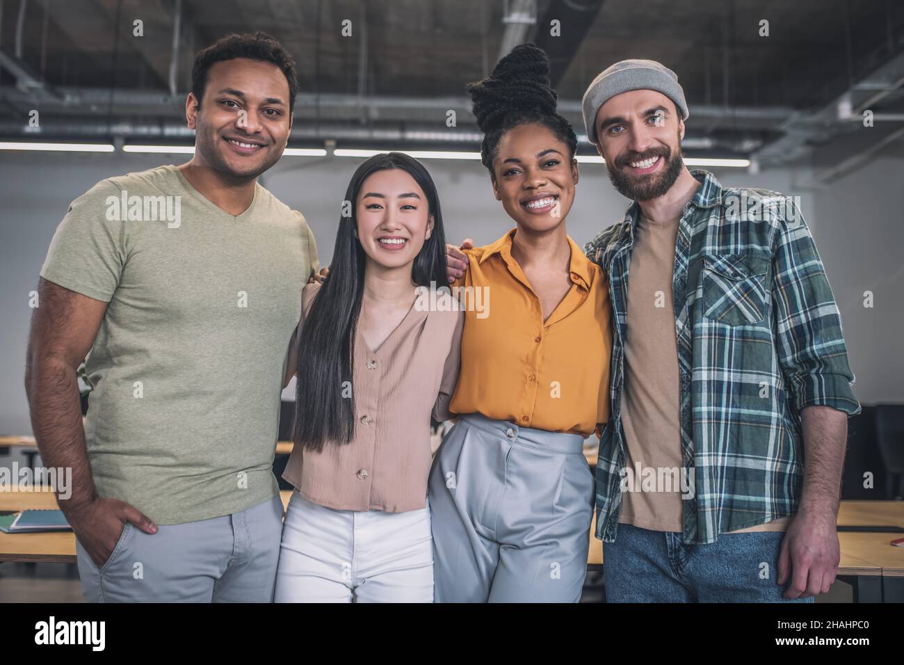 Group of young smiling people looking at camera Stock Photo - Alamy