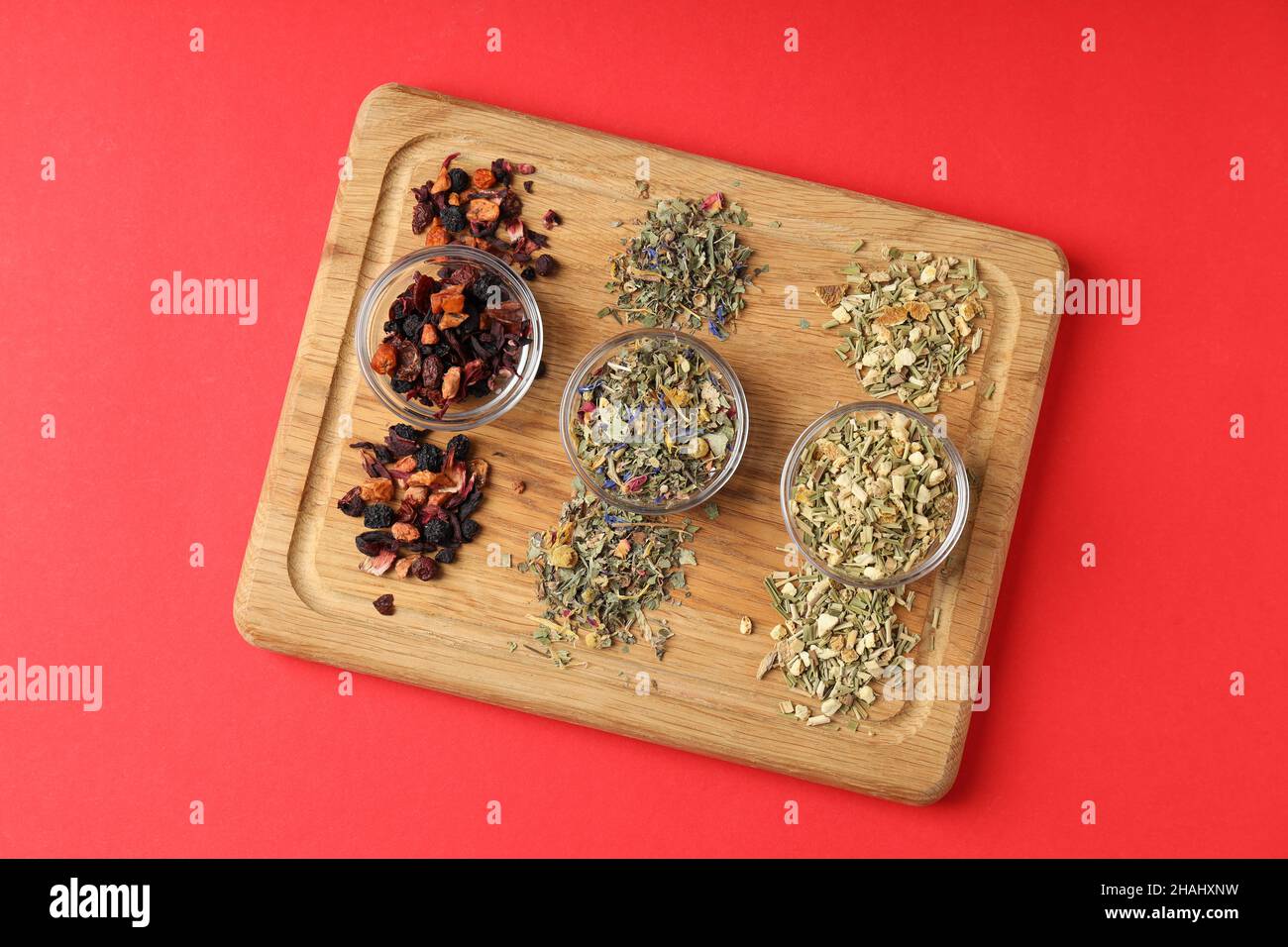 Concept of cooking tea with different types of tea on red background ...