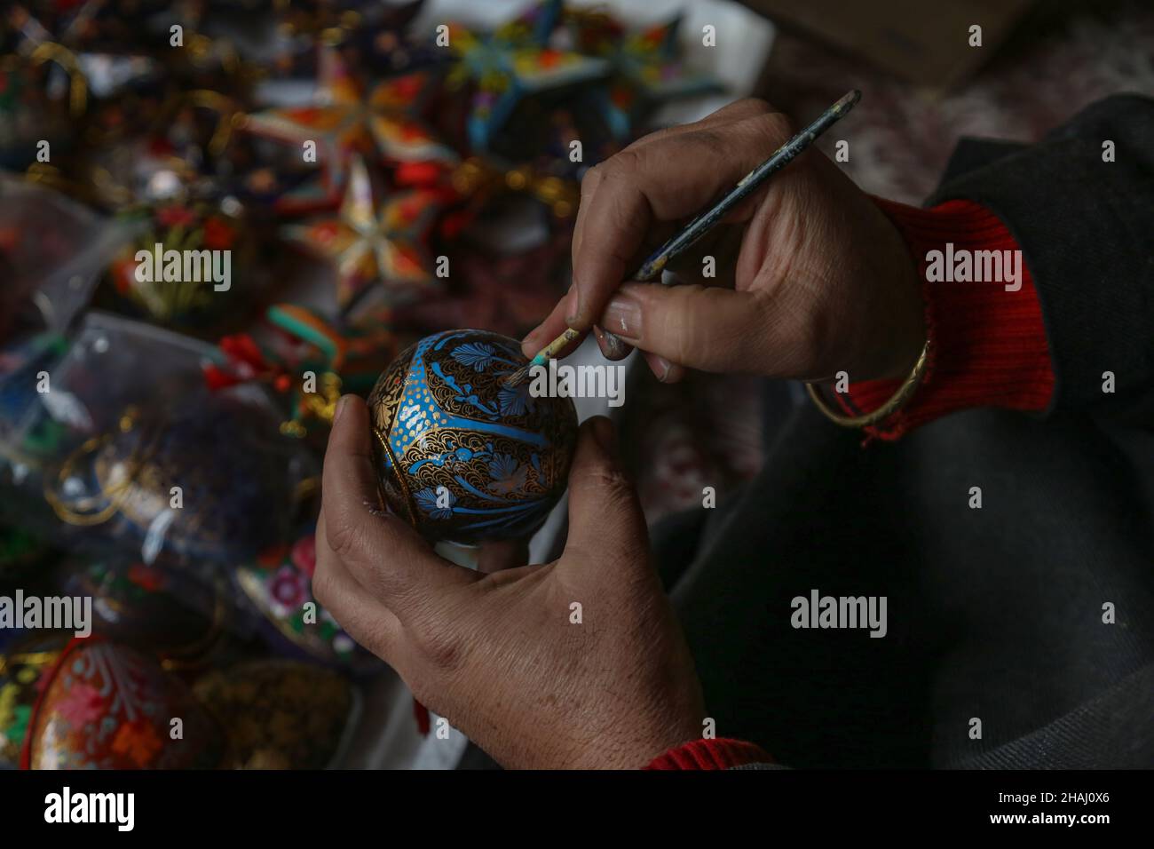 December 13, 2021, Srinagar, Jammu and Kashmir, India Kashmiri artisan giving finishing touch