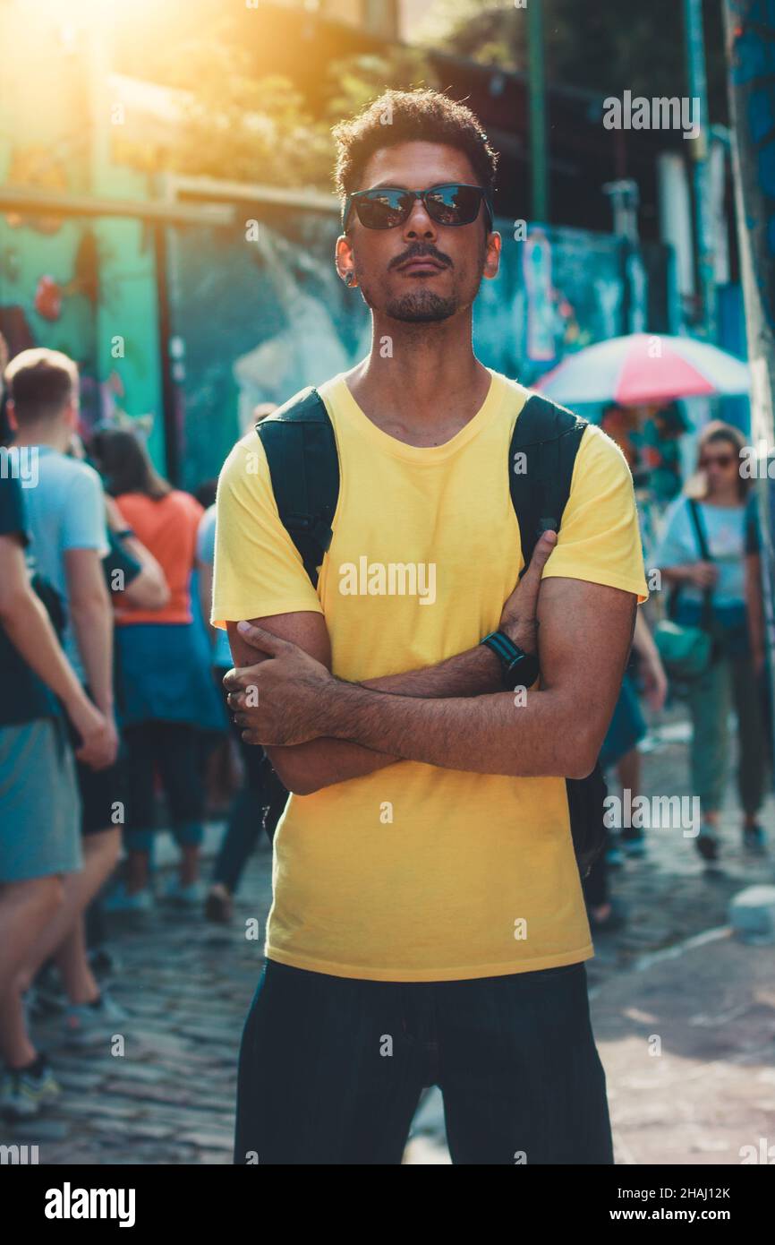 Handsome Black Man in Yellow Shirt and Glasses on Street Background