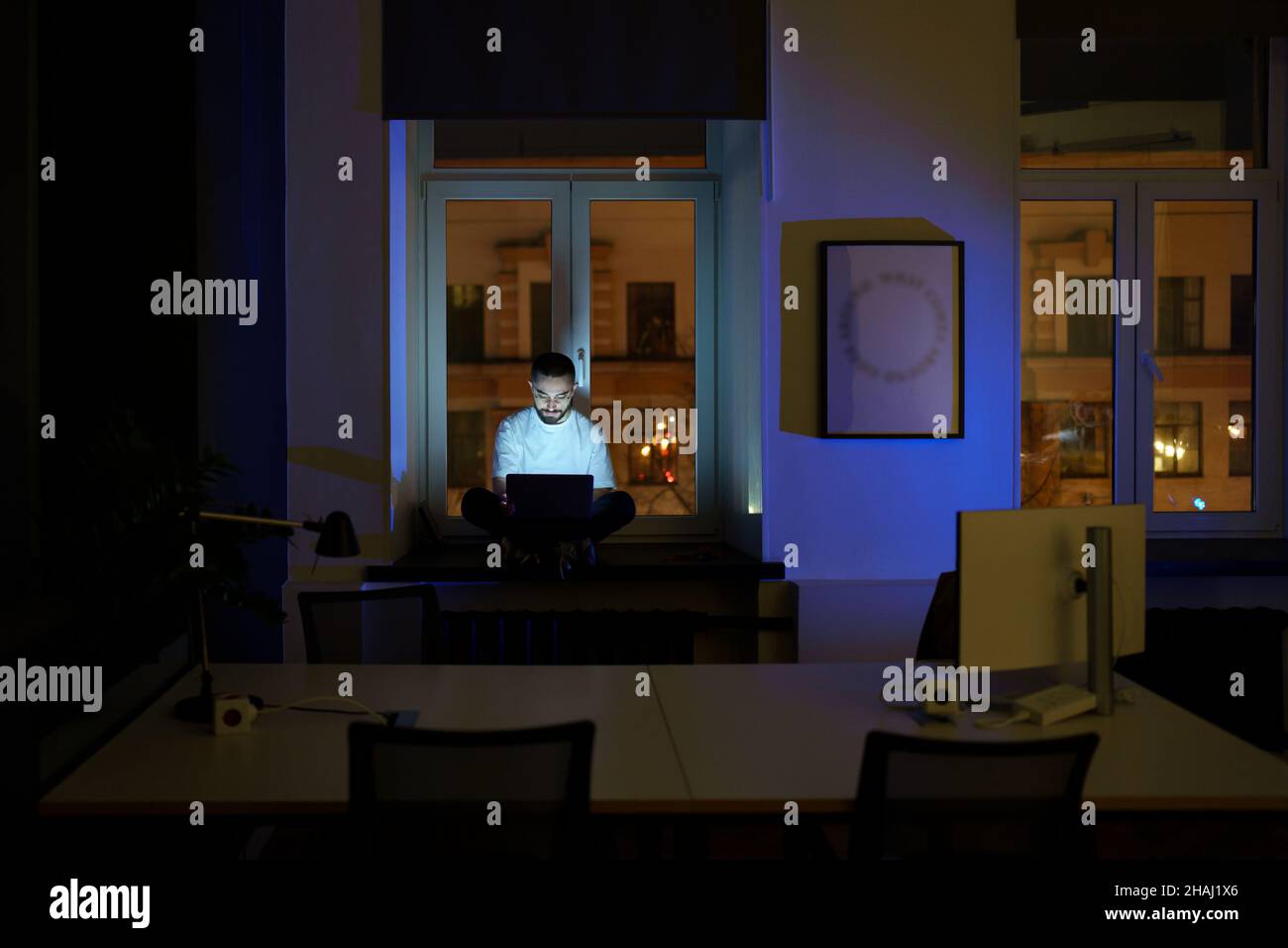 Freelancer programmer work on laptop late at night. Web developer coding overtime before deadline Stock Photo