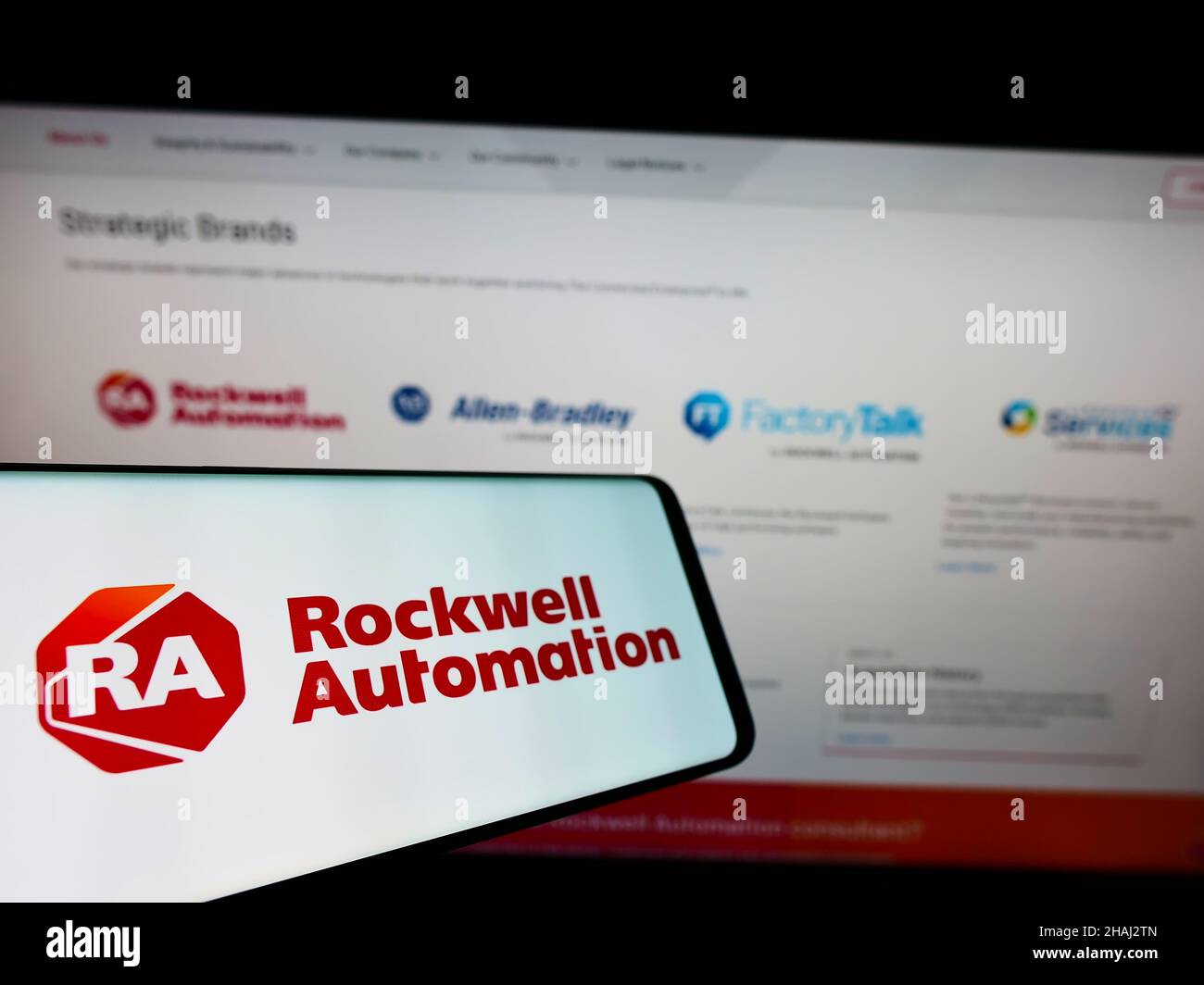 Mobile phone with logo of American company Rockwell Automation Inc. on screen in front of business website. Focus on left of phone display. Stock Photo