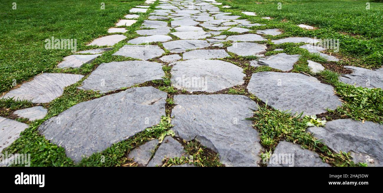 Paving stone coating in perspective. Old Stone Road Stock Photo