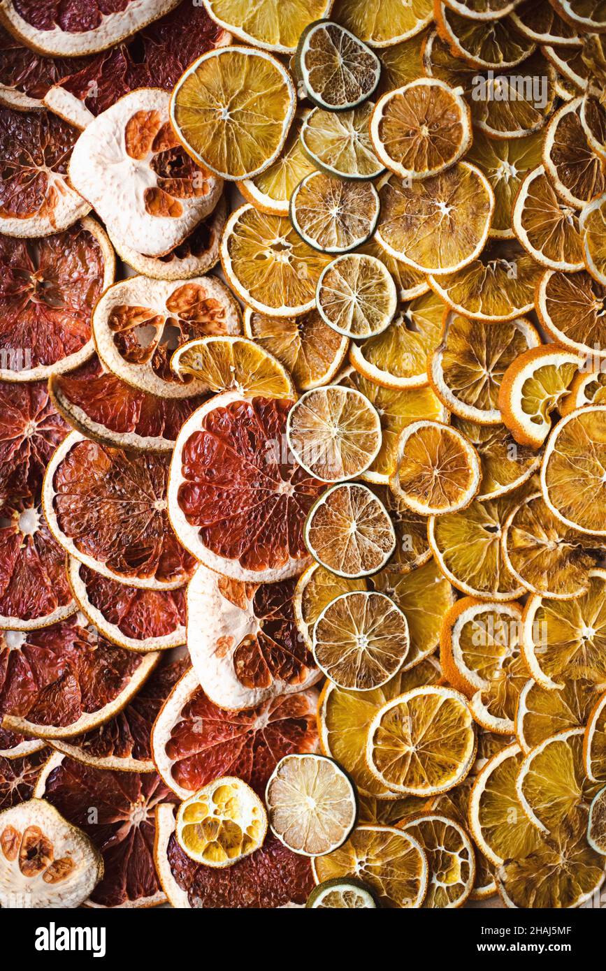 Dried citrus slices, orange, grapefruit and lime, preparing for natural citrus garlands for holiday decoration, winter solstice, yule decor Stock Photo