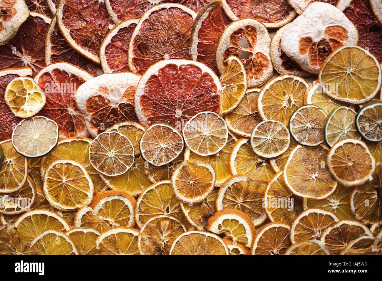 Dried citrus slices, orange, grapefruit and lime, preparing for natural citrus garlands for holiday decoration, winter solstice, yule decor Stock Photo
