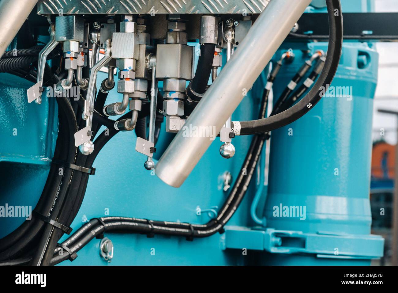 There are many hydraulic hoses and a hydraulic crane lifting control