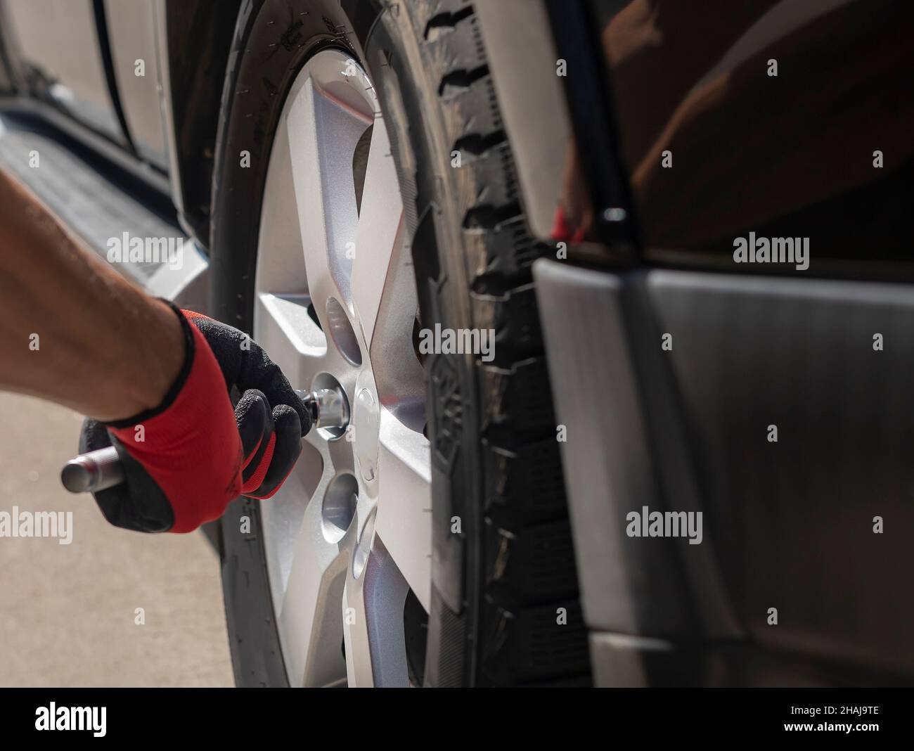 Checking wheel of car with metal tool, close up Stock Photo Alamy
