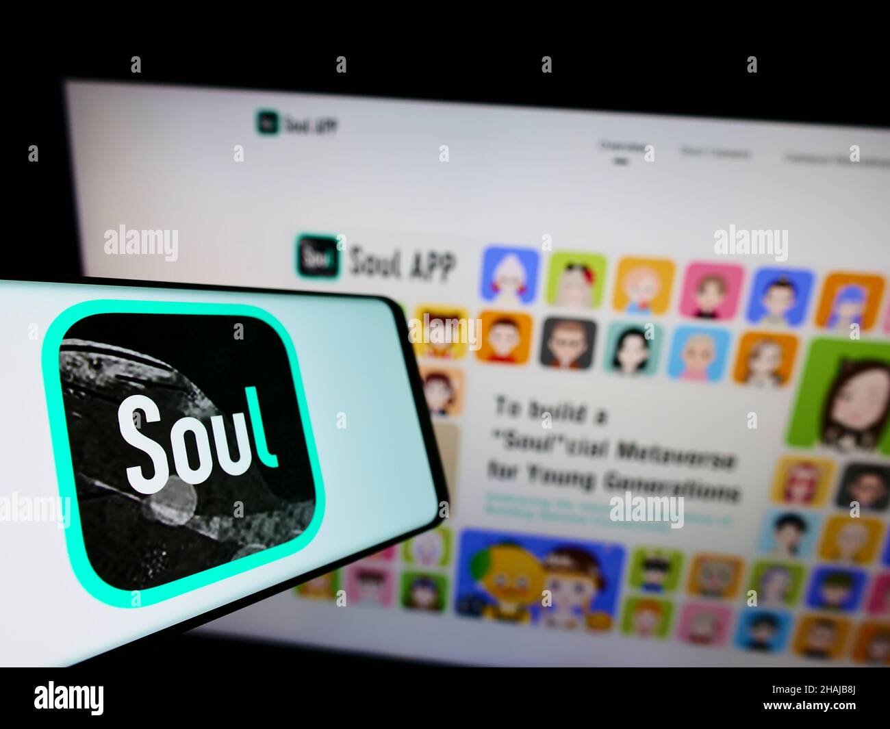Cellphone with logo of Chinese social network company Soulgate Inc. (Soul) on screen in front of website. Focus on center-left of phone display. Stock Photo