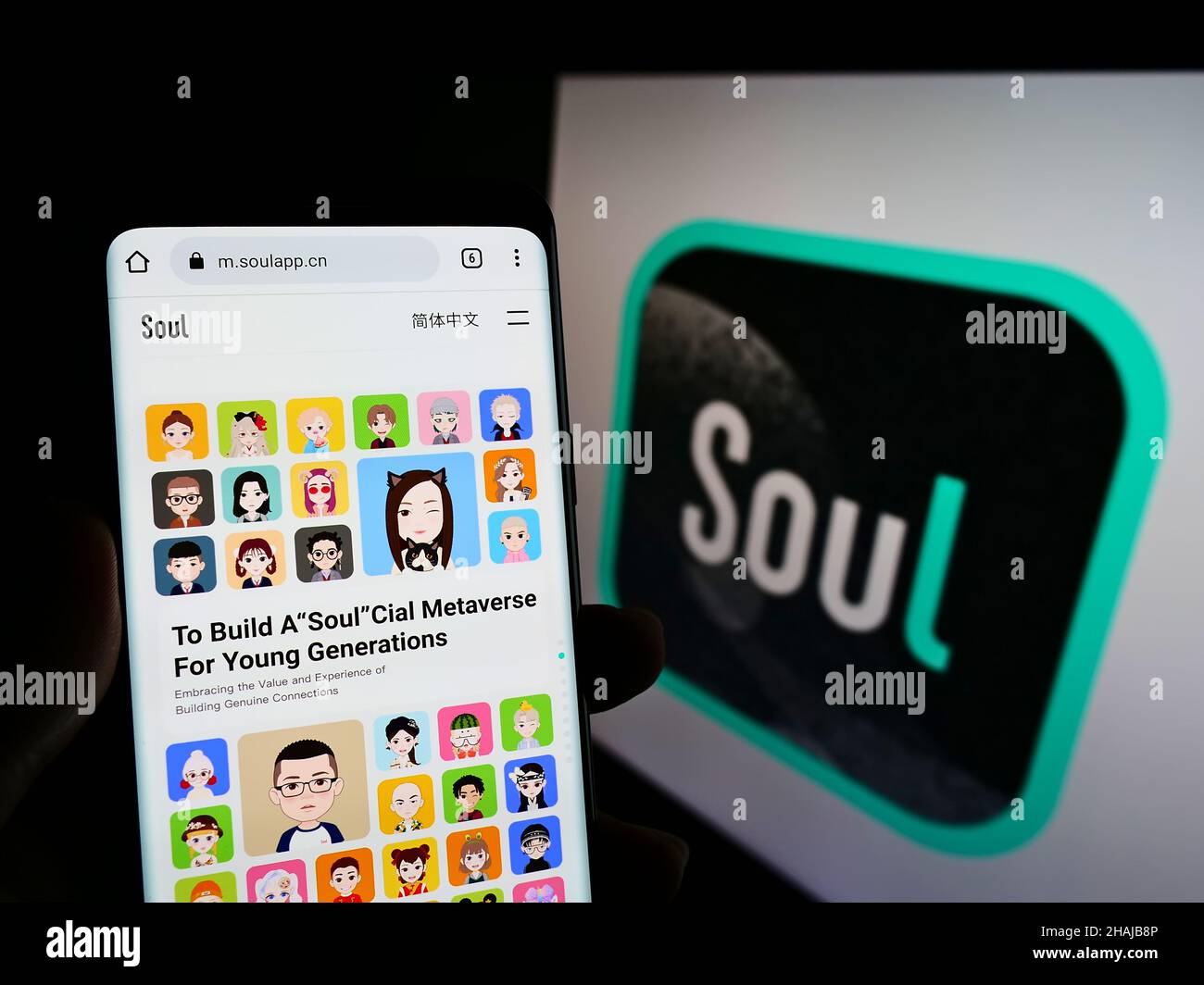 Person holding smartphone with website of Chinese social network company Soulgate Inc (Soul) on screen with logo. Focus on center of phone display. Stock Photo