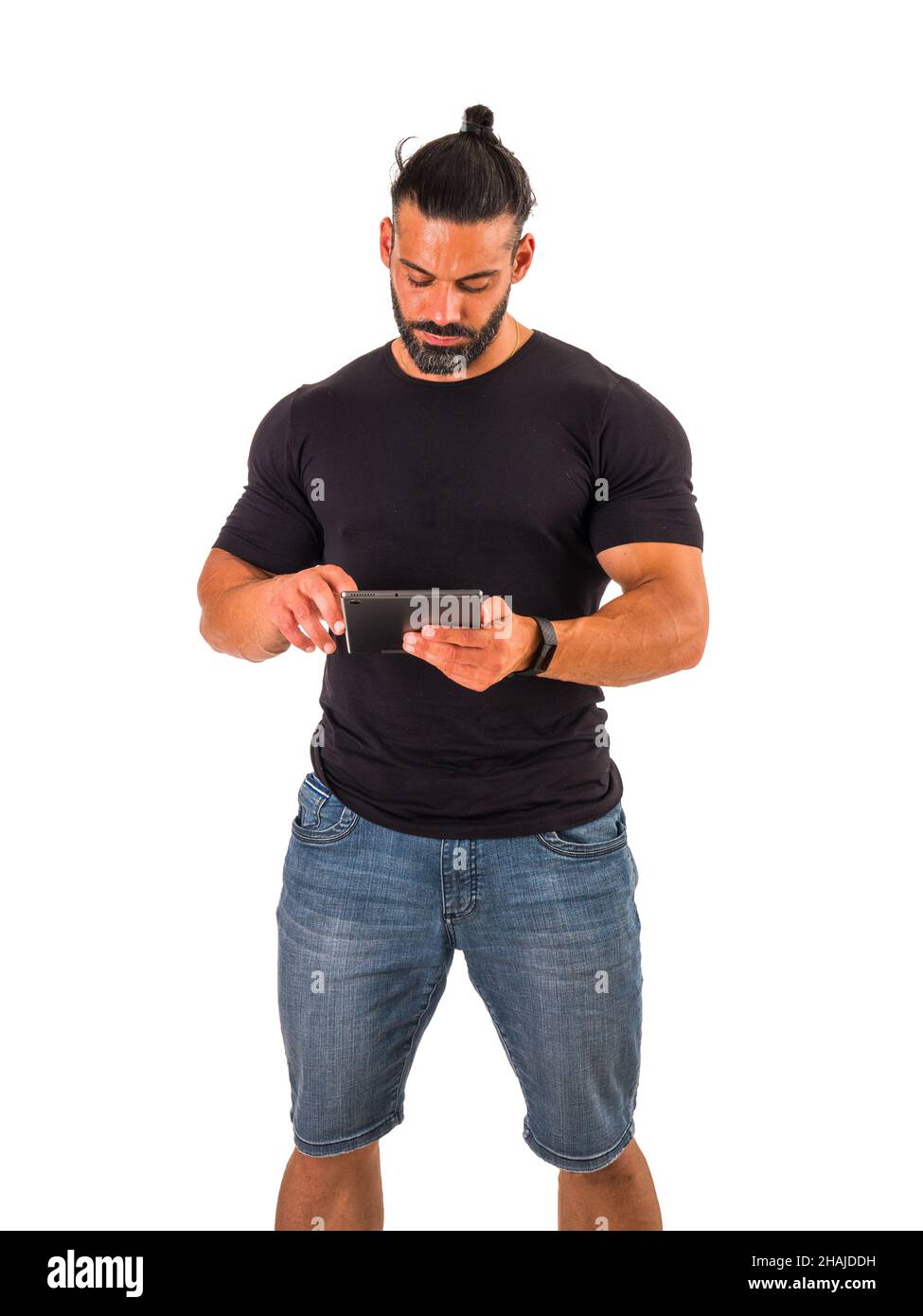 Attractive muscular man using electronic tablet in studio Stock Photo