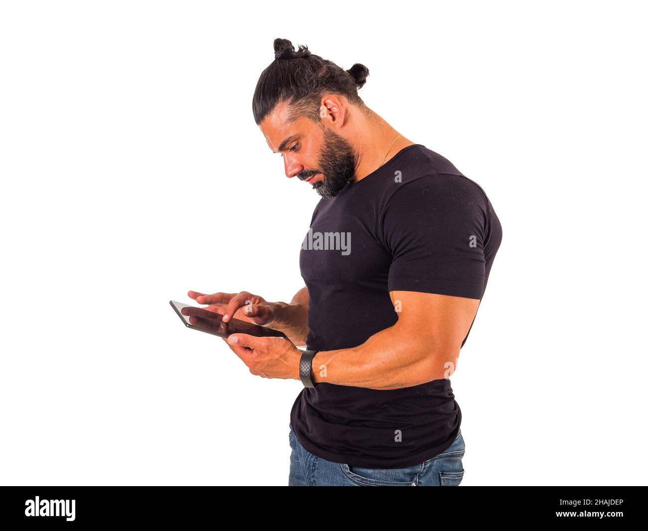 Attractive muscular man using electronic tablet in studio Stock Photo